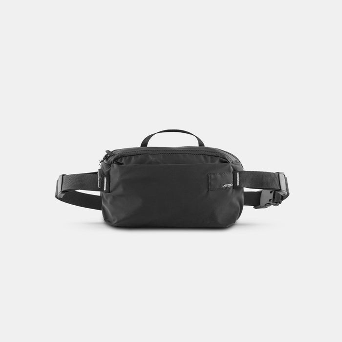 front view of black sling bag on light gray background
