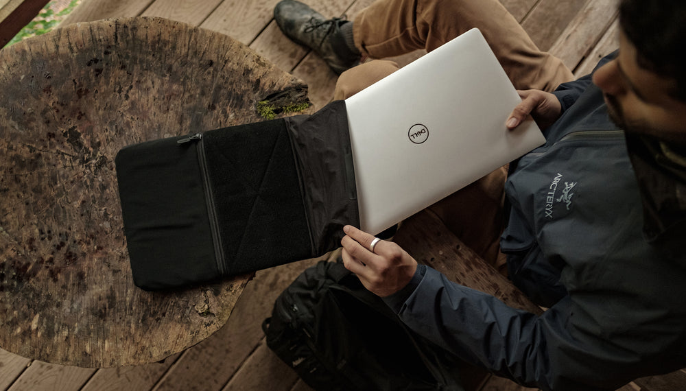 Man pulling laptop out of Laptop Base Layer