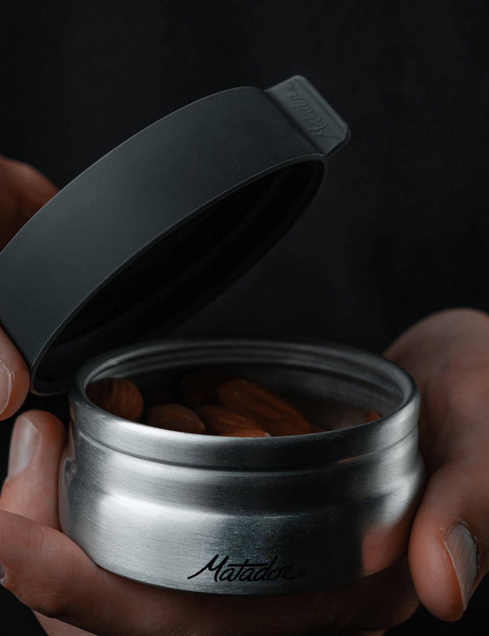 opening canister to reveal almonds
