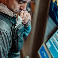 Man at ticket station, placing tickets into Speed Stash pocket