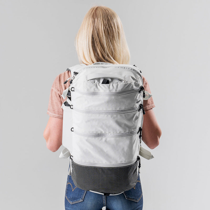 back view of woman wearing white SEG28 on light gray background