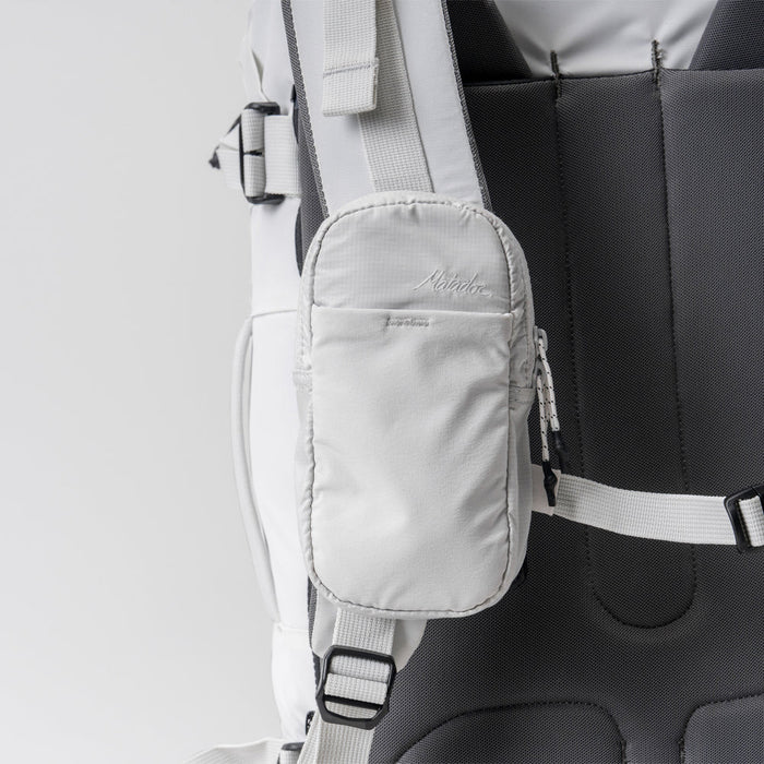 front view of white speed stash on white backpack strap