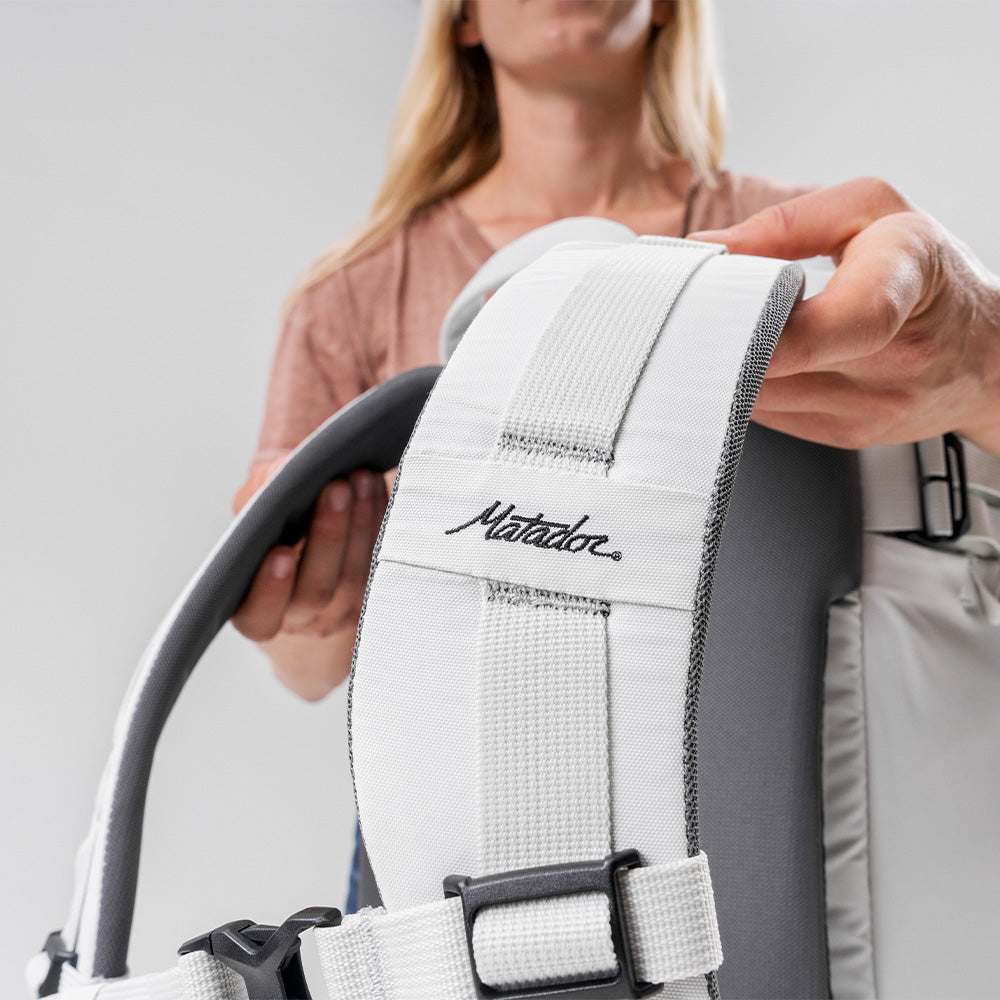 close up view of matador logo and padded shoulder straps of white seg28