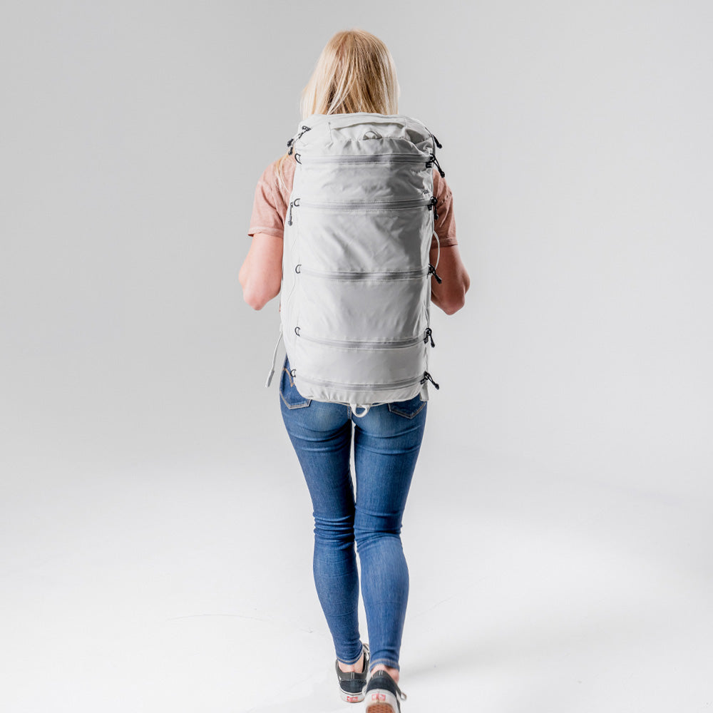 back view of blonde woman wearing White SEG45 on white background