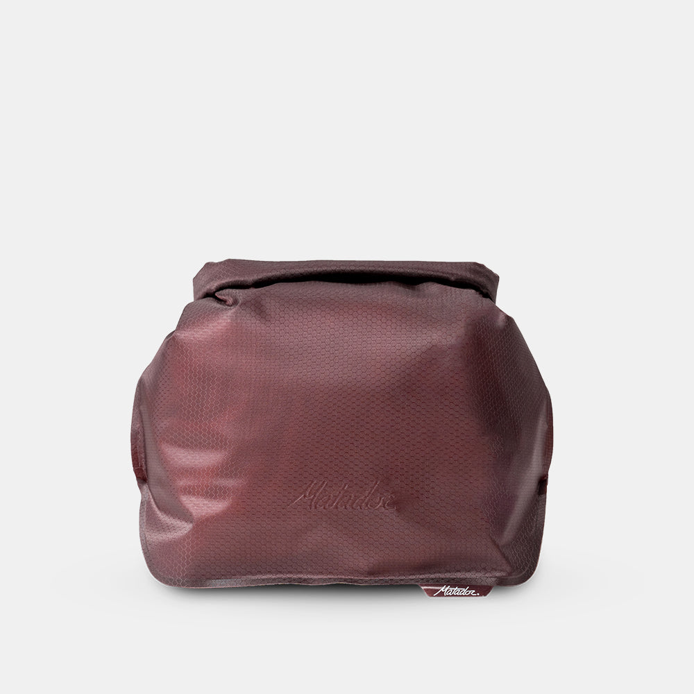 Garnet waterproof toiletry case on light gray background