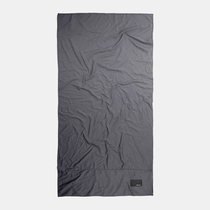 Top-down view of full charcoal towel on light gray background