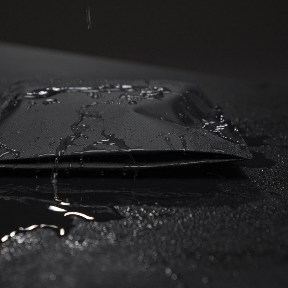 Toiletry Case on black background with water beading off