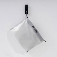 front view of white zipper toiletry case hanging from black hook