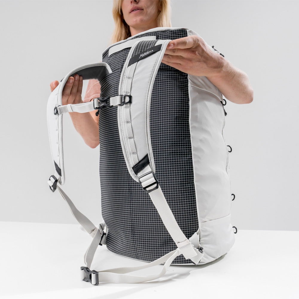 woman with White SEG45 on white table, showing harness system and UHMWPE fabric backing