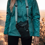 Woman wearing base layer covered camera around neck