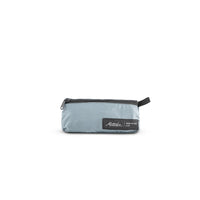 packed up slate blue sling bag on white background