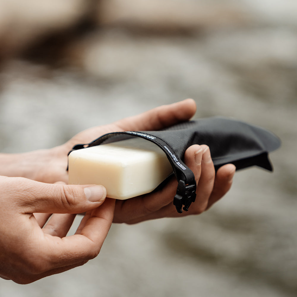 Hand pulling soap bar out of soap bar case