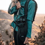 Woman taking camera out of base layer