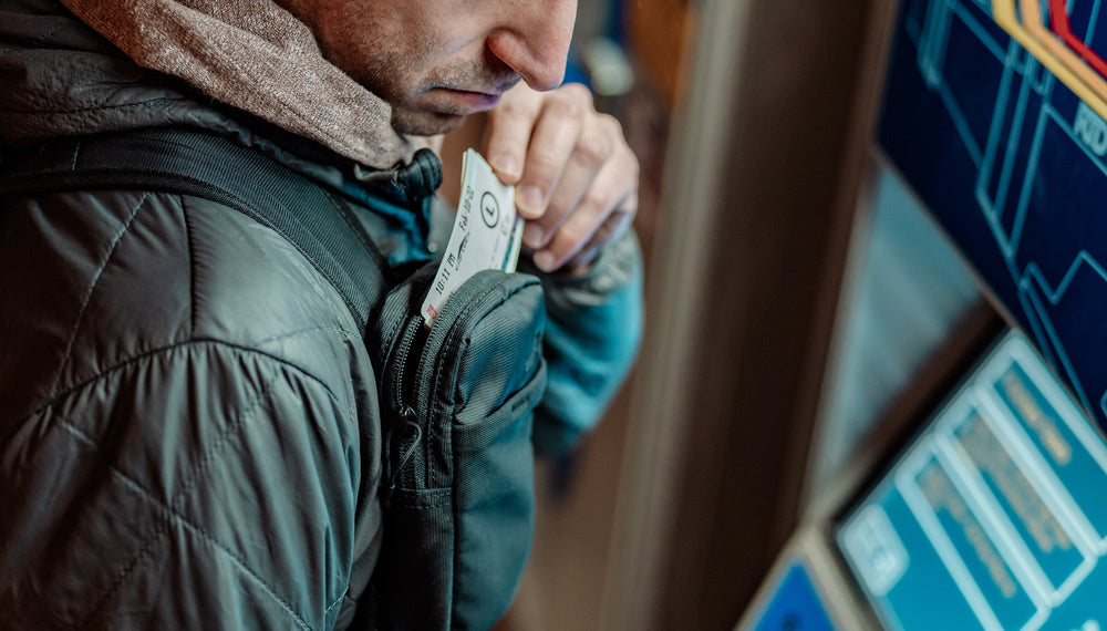 Man at ticket kiosk, placing ticket into Speed Stash pocket