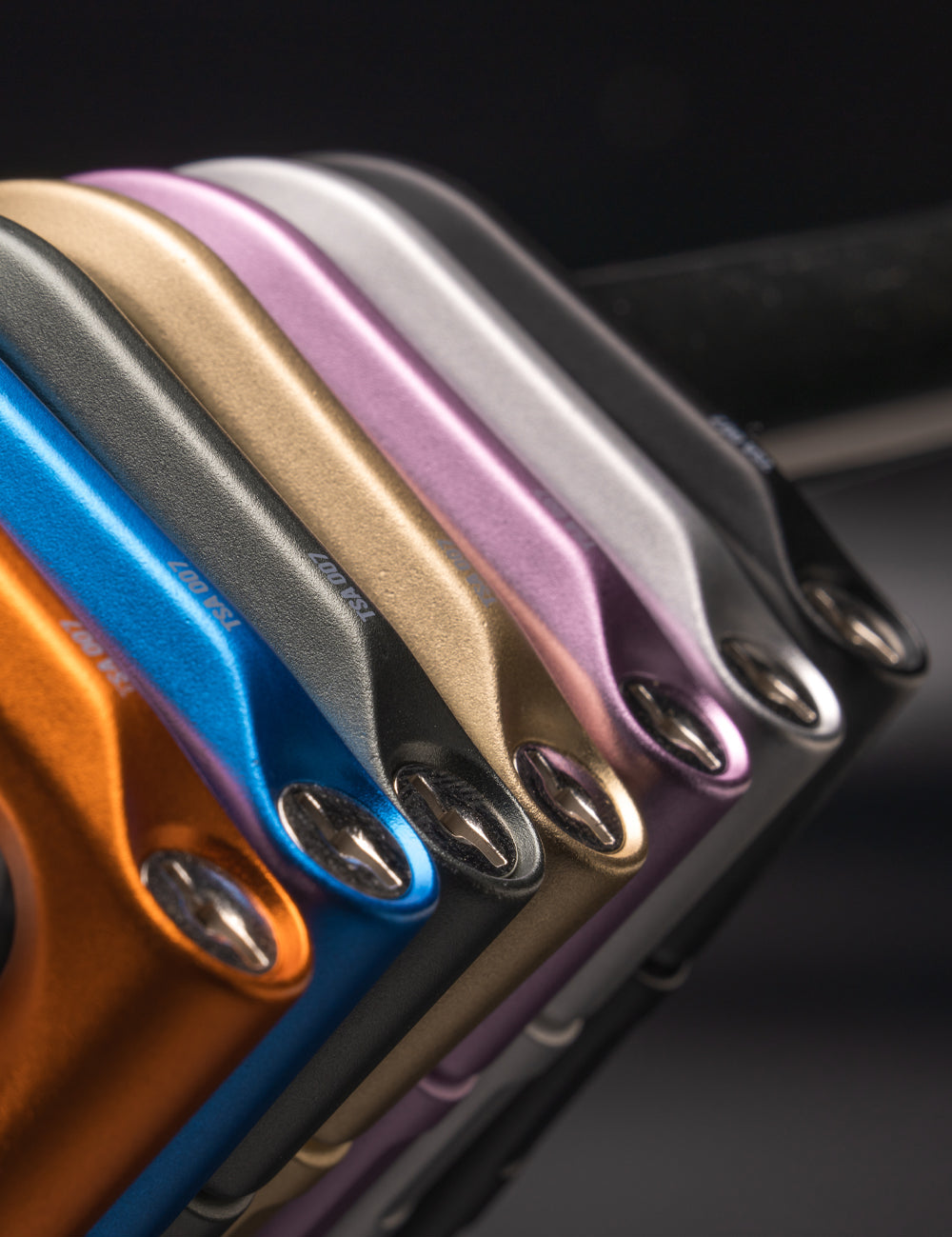 close up view of orange, blue, green, gold, orchid, metal, and black betalocks