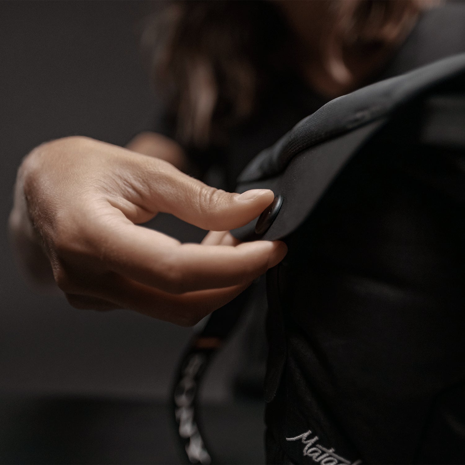 Woman snapping the base layer top closed