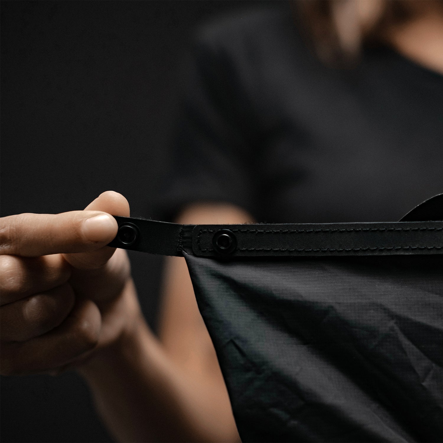 Close up view of hands displaying snap buttons