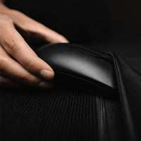 Close up view of hand putting computer mouse in zipper pocket