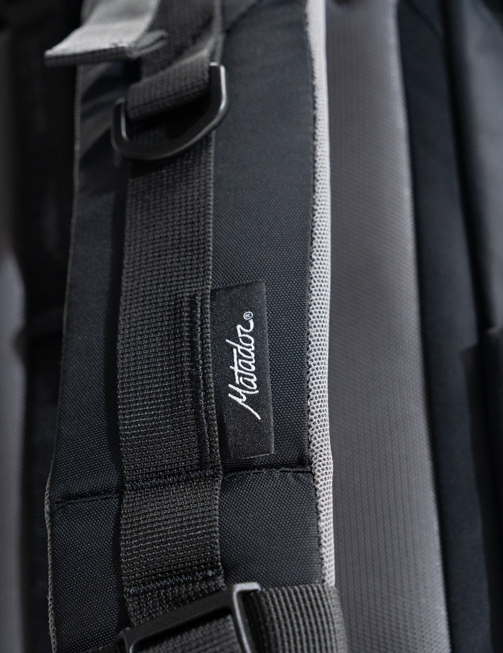 close up view of backpack strap with Matador woven tag