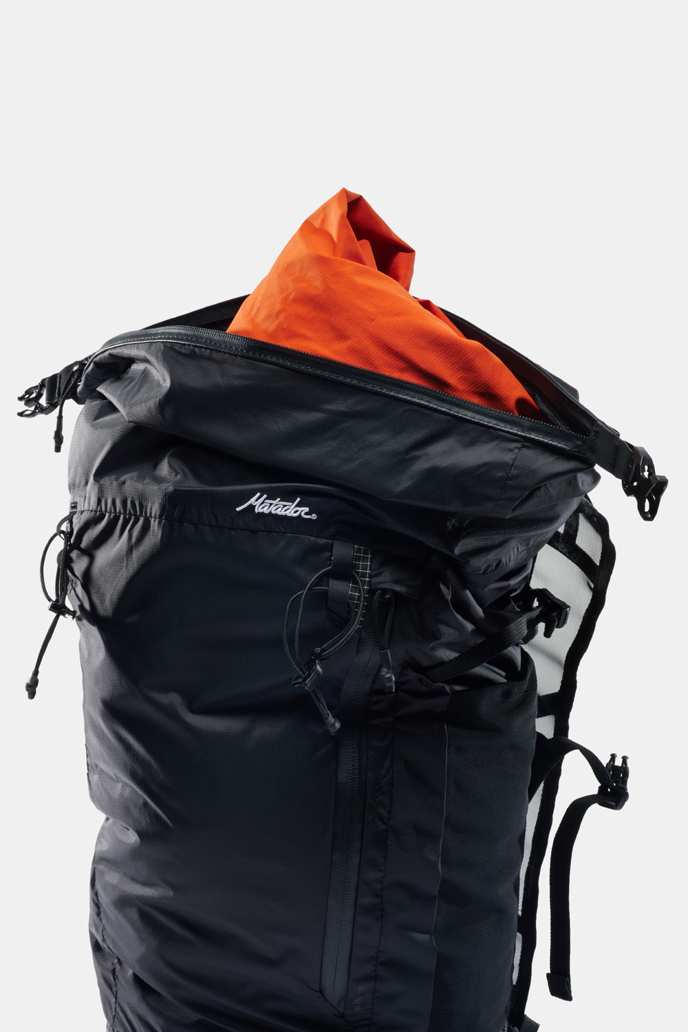 black waterproof bag with orange jacket peeking out top