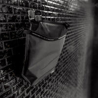 Open FlatPak Toiletry Case hanging on shower hook from hang loop