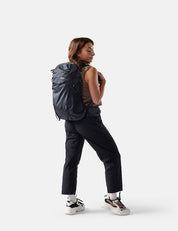 Person wearing a black backpack on a white background