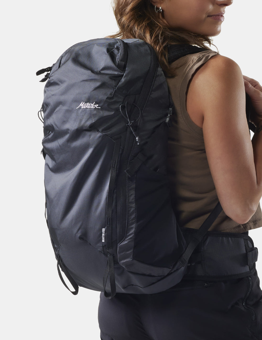 woman wearing black backpack on white background