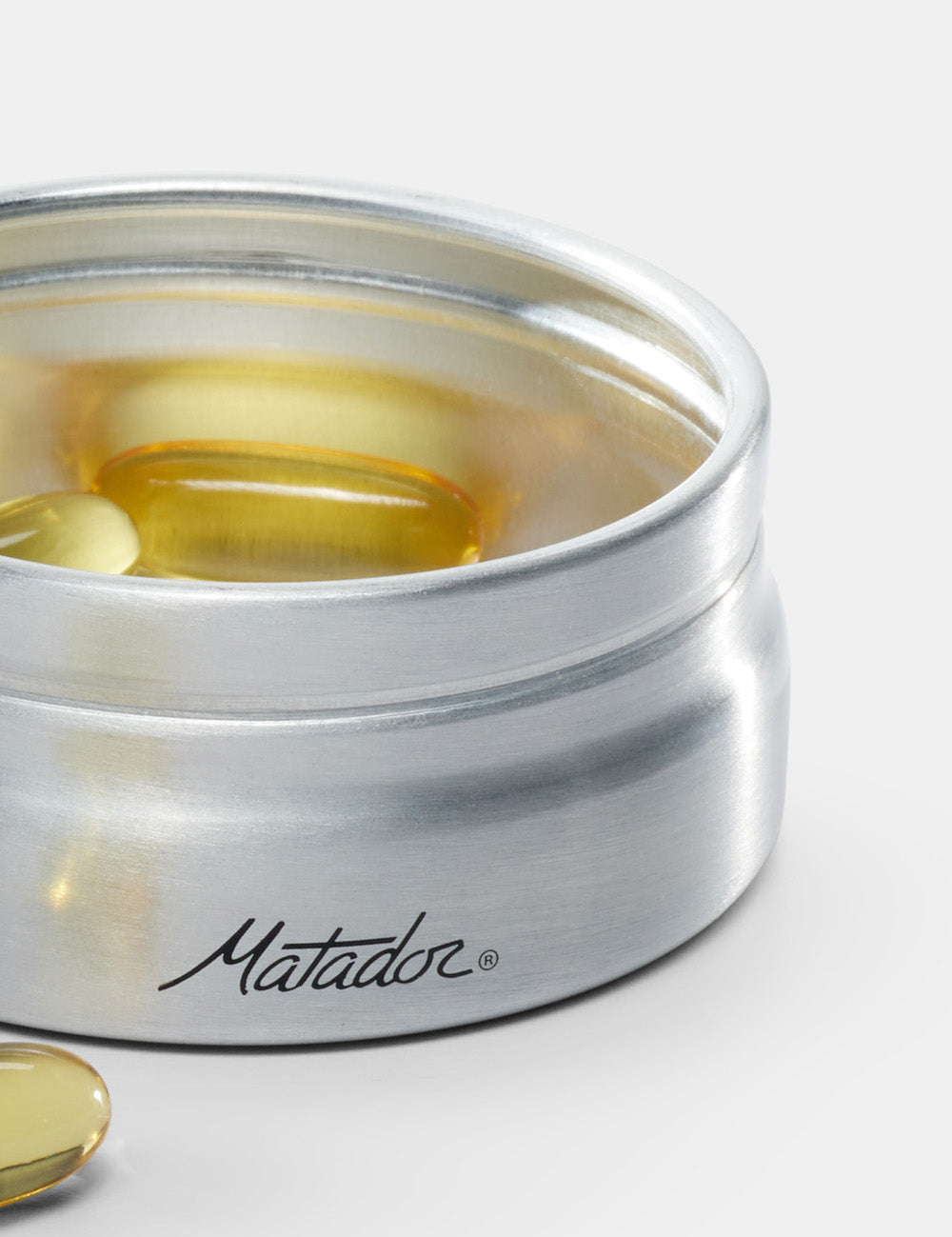 close up view of aluminum canister with pills inside