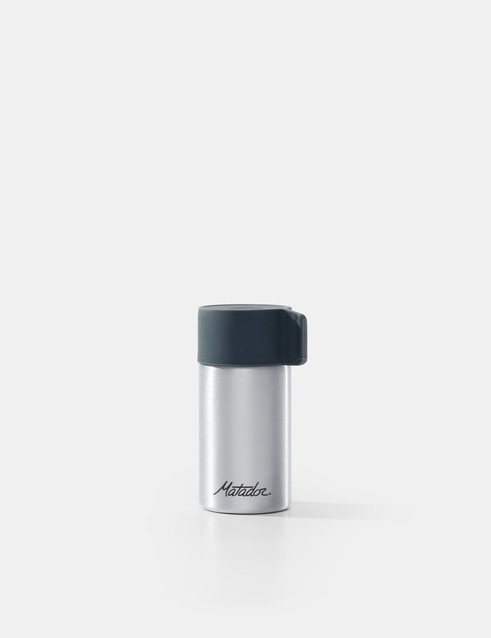 Silver container with black lid on a white background