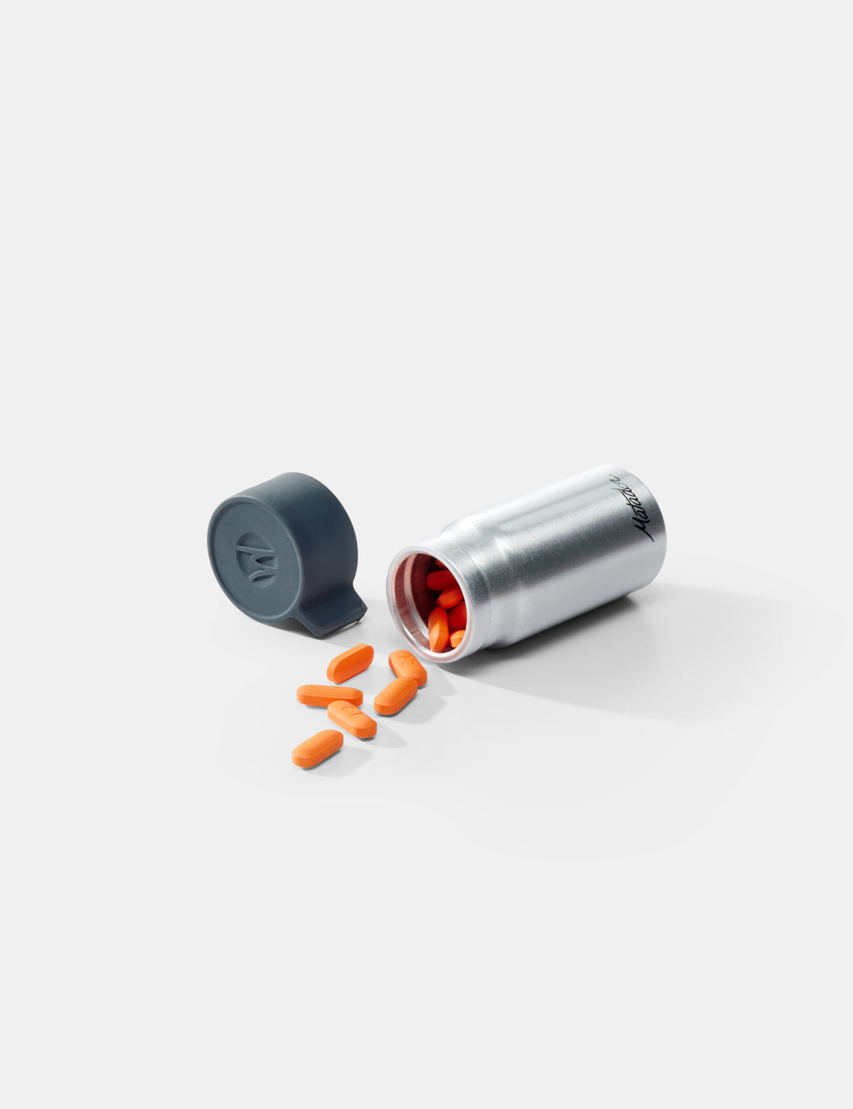 Silver and gray container with orange pills on a white background