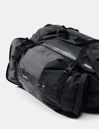 Black duffel bag with visible brand logo on a white background