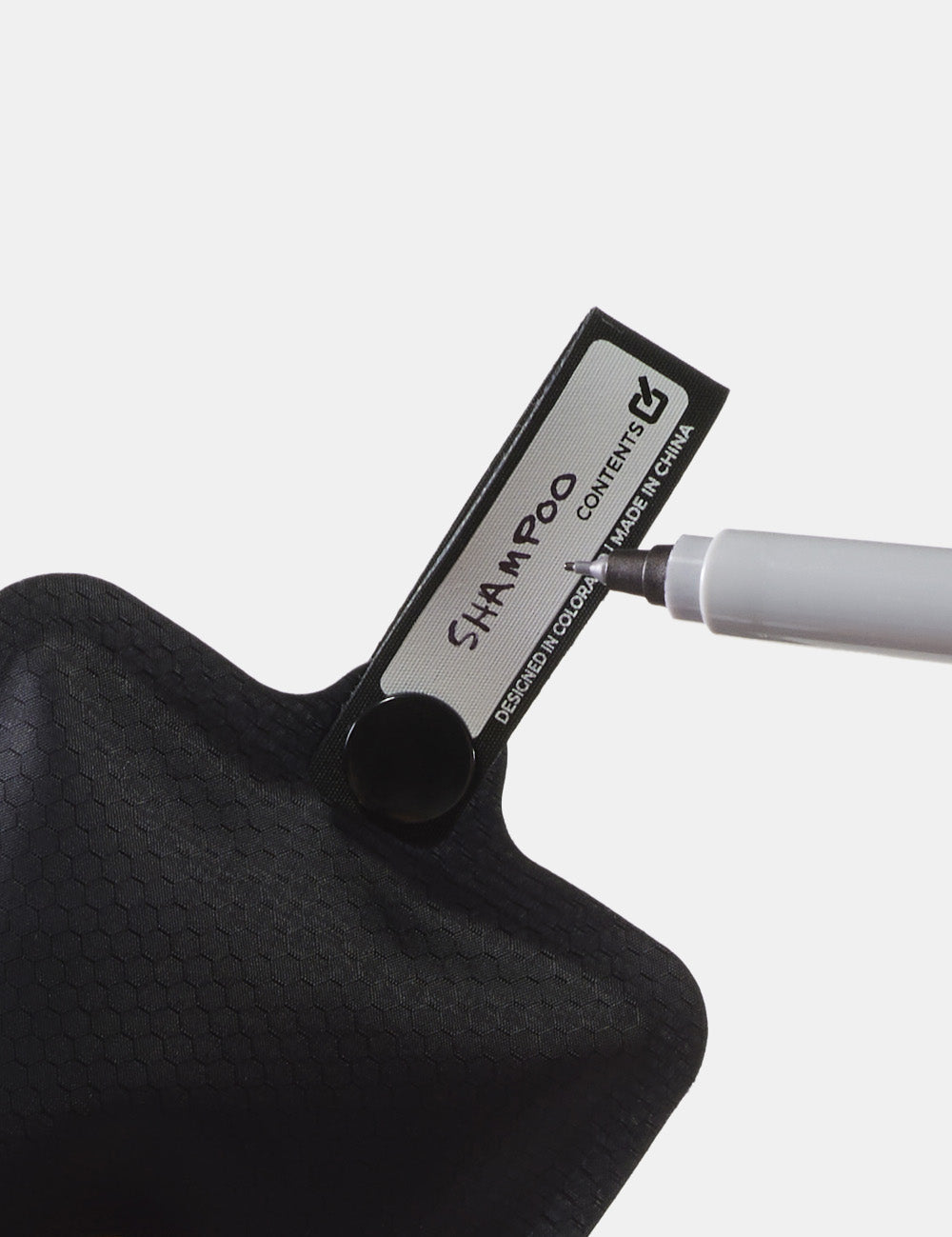 Sharpie writing &quot;shampoo&quot; on toiletry bottle snap loop