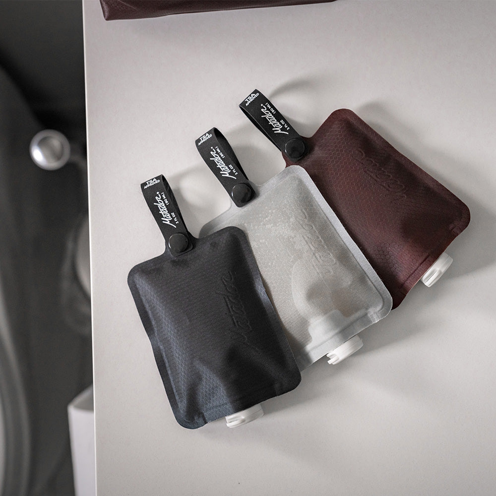 3 toiletry bottles on bathroom counter