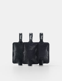 Three black toiletry bottles on a white background