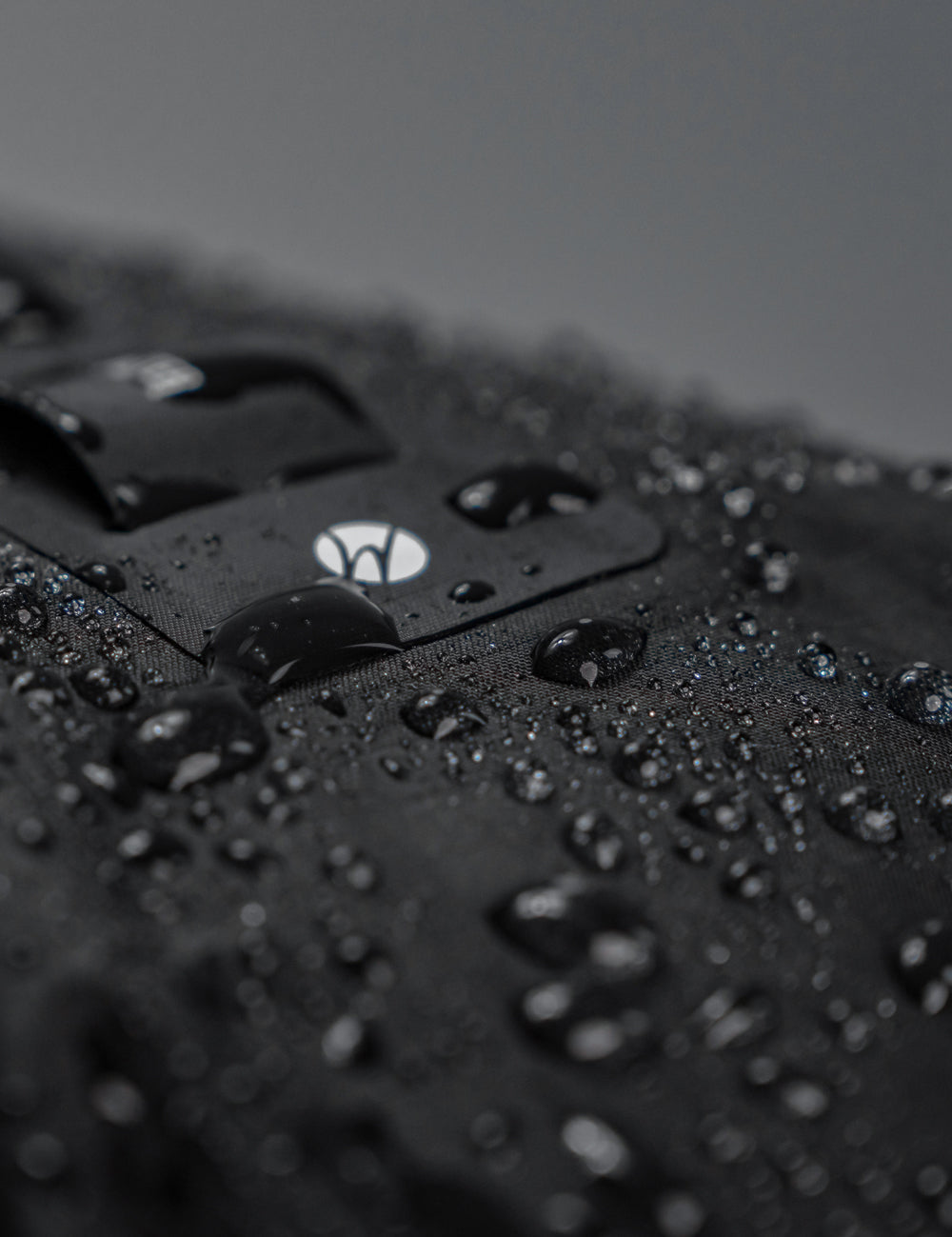 close up view of water beading on black fabric