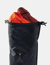 Black bag with orange and brown items inside on a white background
