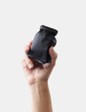 Hand holding soap bar case against a white background