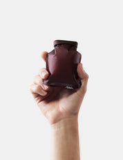 Hand holding garnet soap bar case on white background