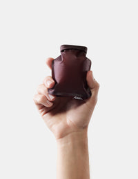 hand holding garnet soap bar case on white background