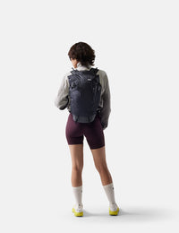 Person wearing a black backpack on a white background