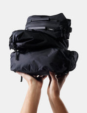 stack of black gear cubes being held up on white background