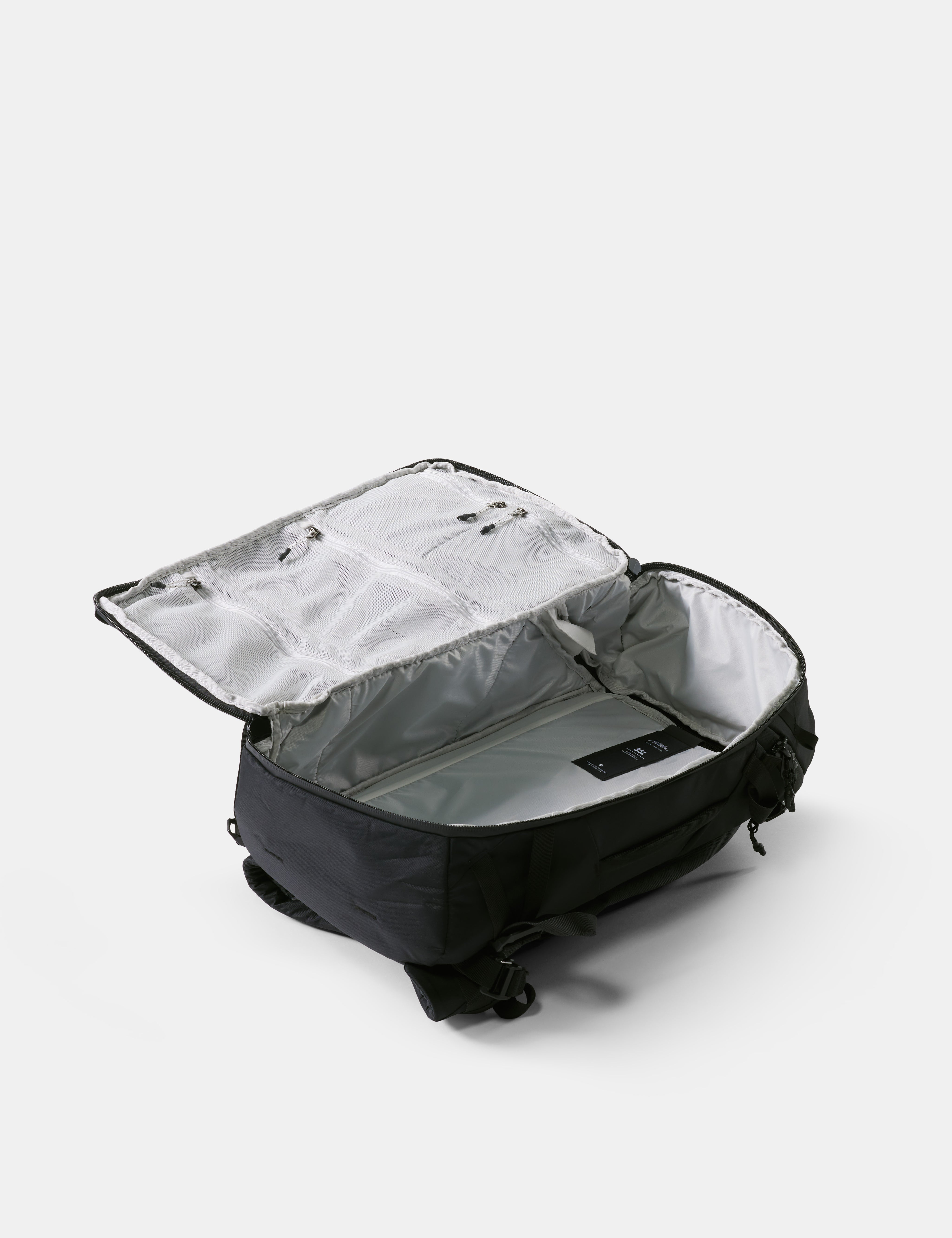 Black backpack with open compartment on a white background