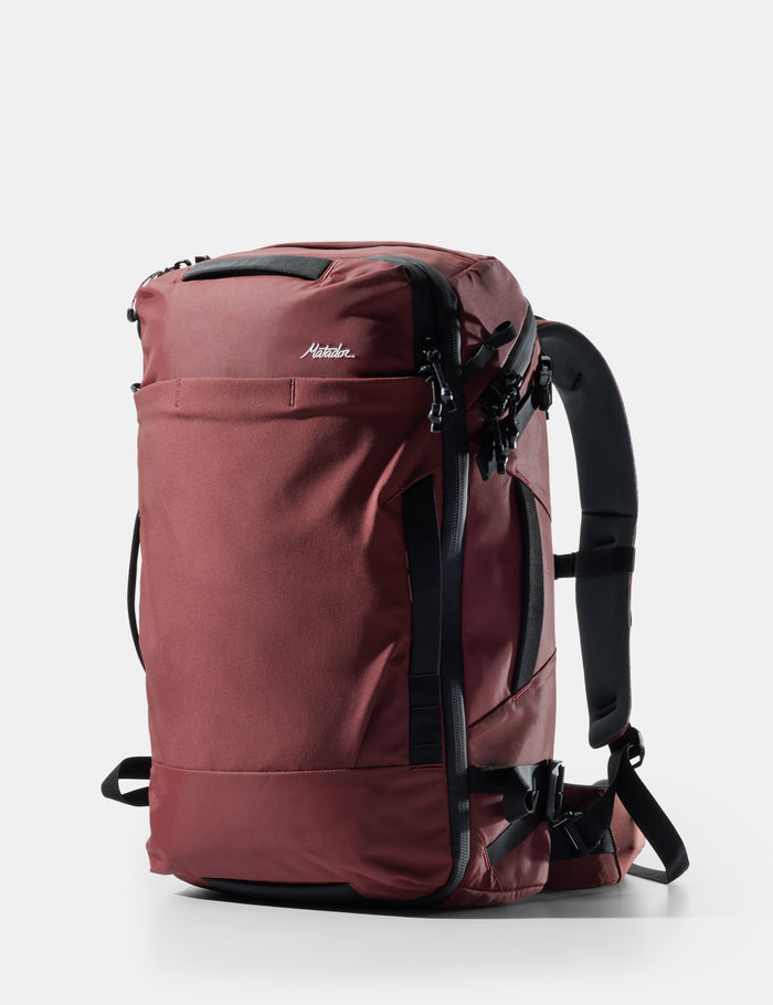 Maroon backpack with black straps on a white background