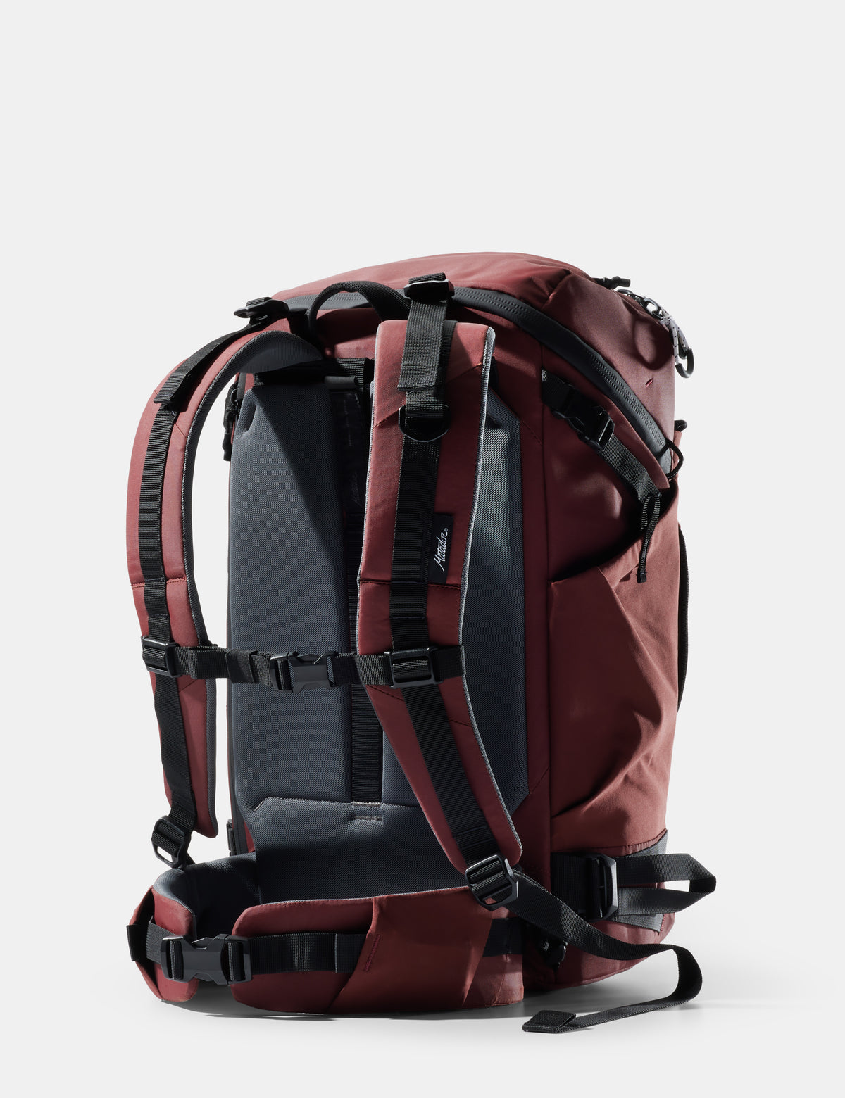 Red backpack with black straps on a light gray background