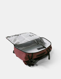 Red backpack with open front compartment on a white background
