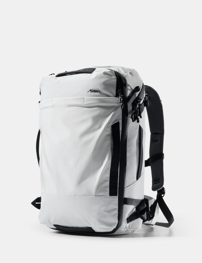 White backpack with black straps on a white background