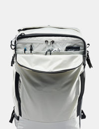 White backpack with black zippers and straps on a white background