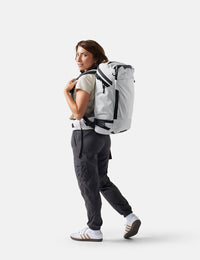Person wearing a white backpack on a white background
