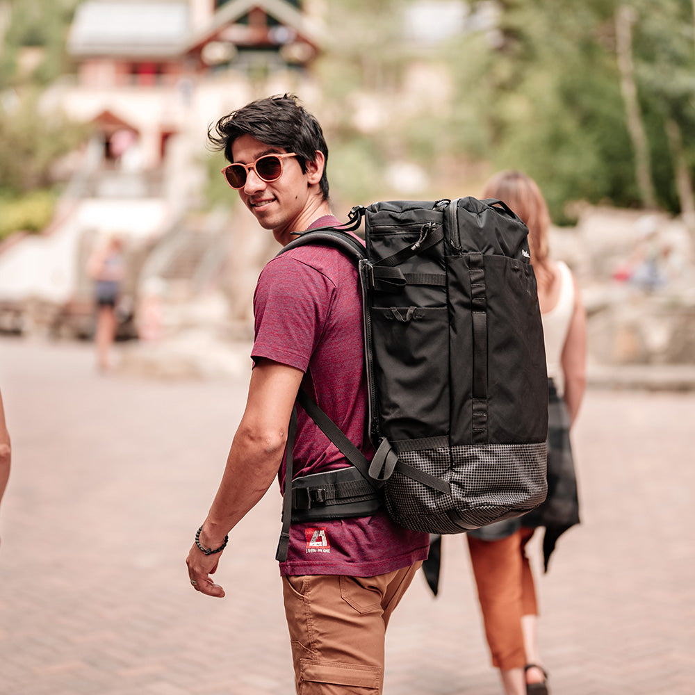 man in Bavarian village wearing black backpack