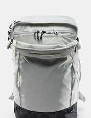 Light gray backpack with multiple zippers on a white background